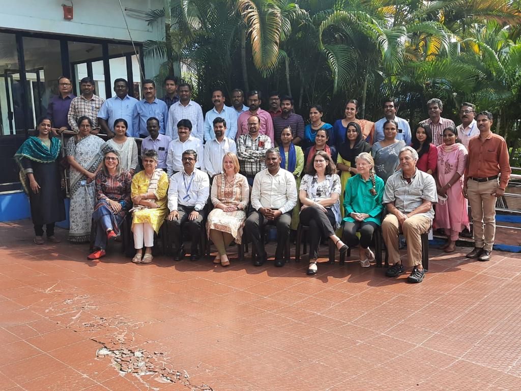 Group outdoor photo in front of palm trees with U.S. FDA, MPEDA Officials, JIFSAN instructors, and participants from Kochi, India Basic Seafood HACCP course.
